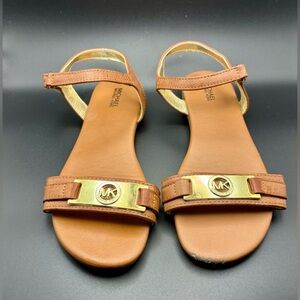 Michael Kors brown flat sandals with a gold-tone MK logo emblem size 4